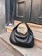Borsa a mano in pelle intrecciata nera per donna
