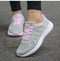 Gray and pink women's running shoes with laces